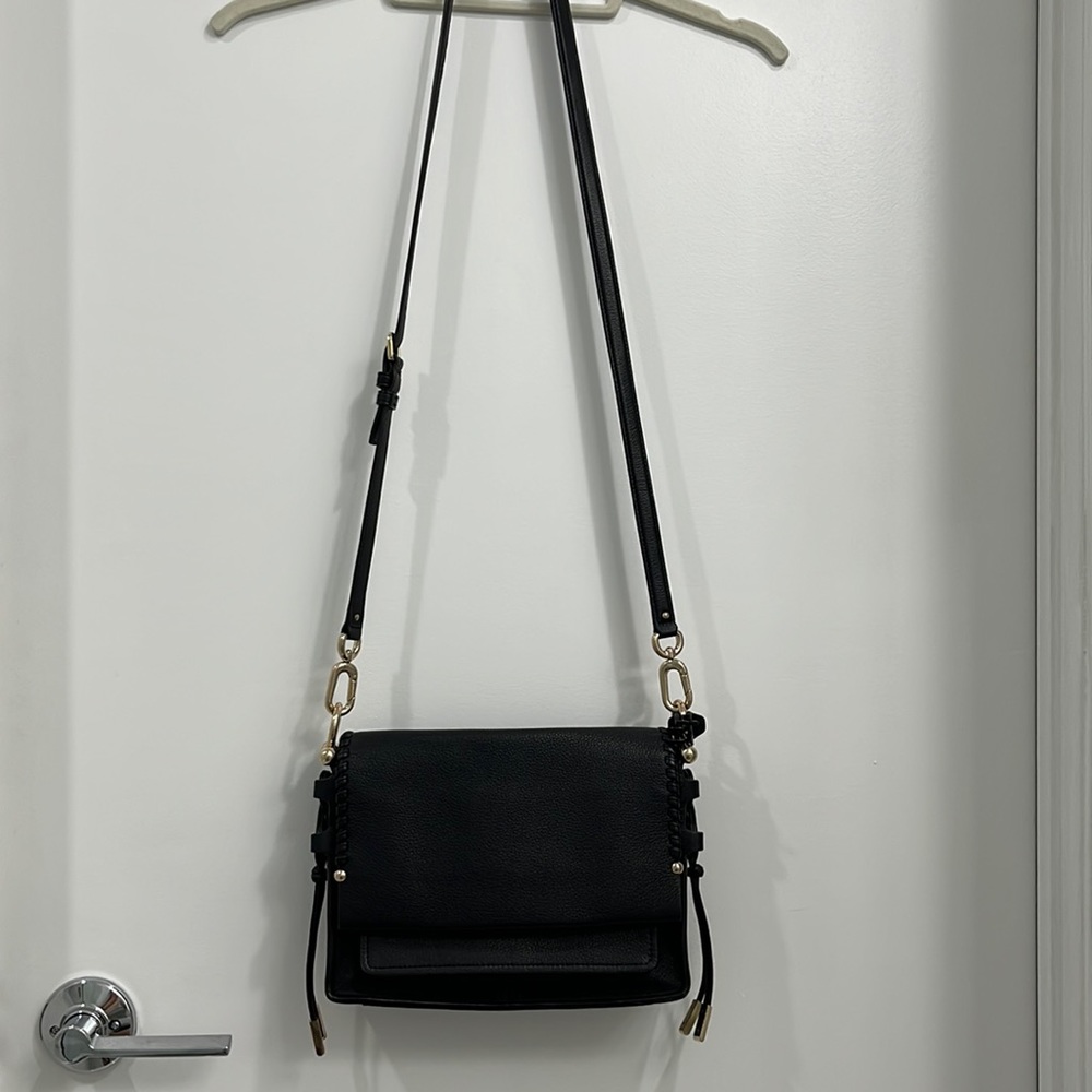 New Stuart Weitzman genuine black leather cross body purse with gold metal
